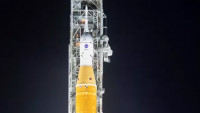 NASA’s Space Launch System (SLS) rocket with the Orion spacecraft aboard is seen illuminated by spotlights atop a mobile launcher at Launch Complex 39B, Friday, March 18, 2022, after being rolled out to the launch pad for the first time at NASA’s Kennedy Space Center in Florida. Ahead of NASA’s Artemis I flight test, the fully stacked and integrated SLS rocket and Orion spacecraft will undergo a wet dress rehearsal at Launch Complex 39B to verify systems and practice countdown procedures for the first launch.