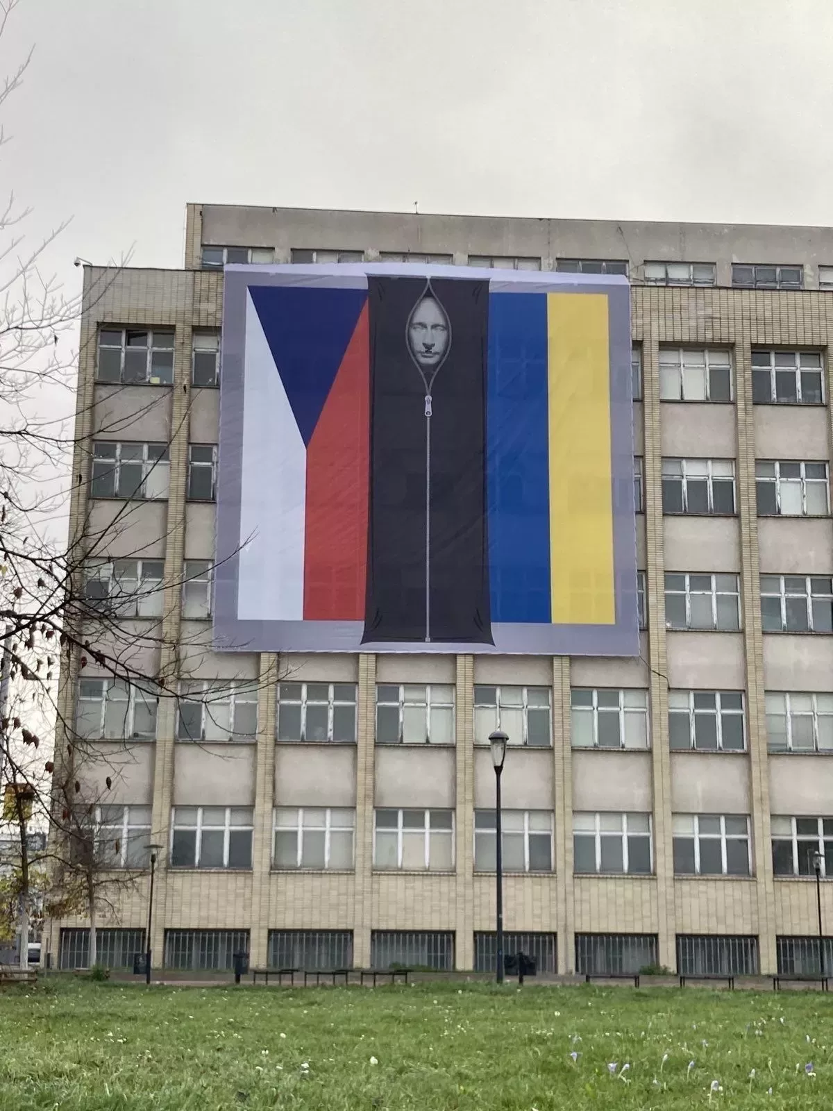 Na budově ministerstva vnitra v Praze visí česká a ukrajinská vlajka, uprostřed se nachází podobizna ruského prezidenta Vladimira Putina ve vaku na mrtvoly.